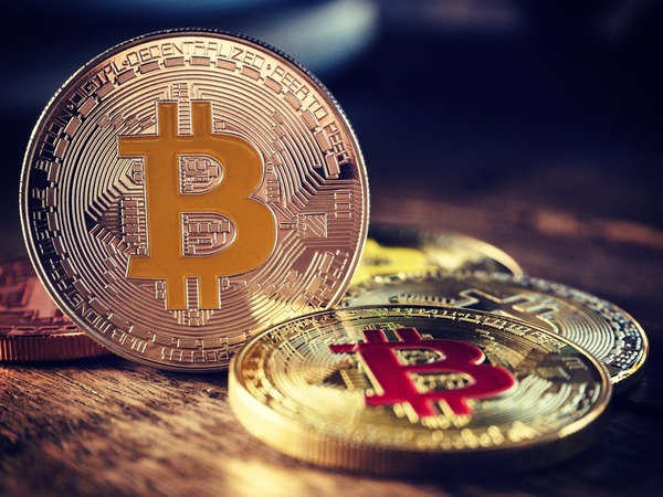 Golden Bitcoin coins on a dark background