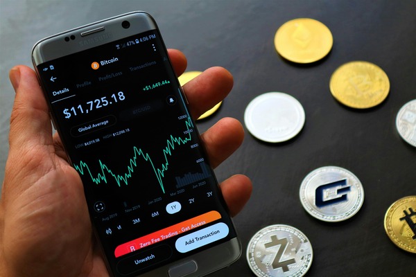 Smartphone with a crypto wallet app next to coins