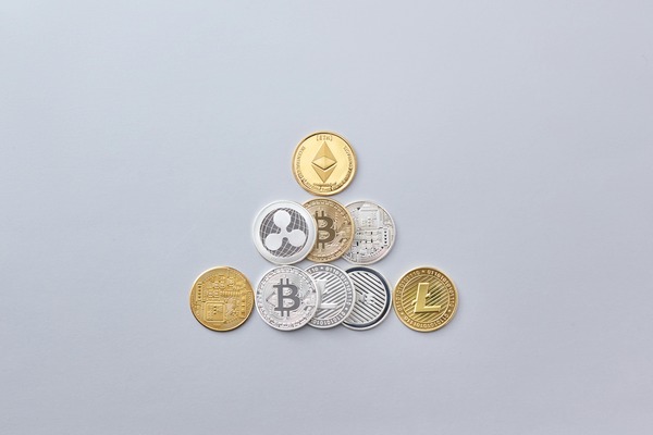 Assorted cryptocurrency coins arranged on a white surface