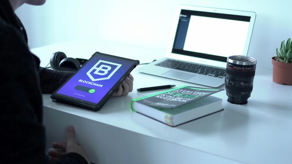 Laptop and tablet showing a blockchain wallet application