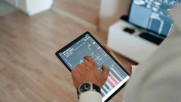 Tablet displaying order status and price charts
