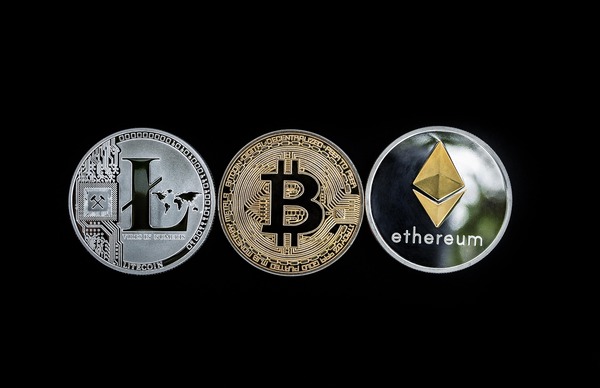 Litecoin, Bitcoin and Ethereum coins on a black background