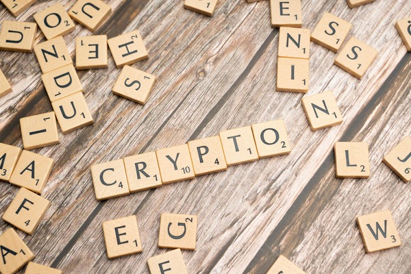 Wooden letter tiles spelling crypto on a table