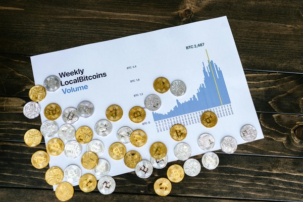 Crypto coins scattered over a printed supply chart