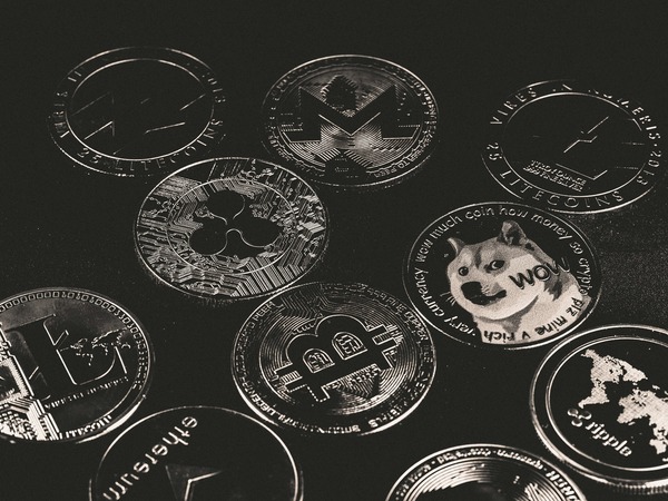 Engraved cryptocurrency coins on a dark background