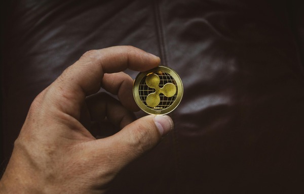 Hand holding a Ripple XRP coin