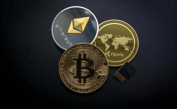 Ripple, Ethereum and Bitcoin coins on a dark blue surface